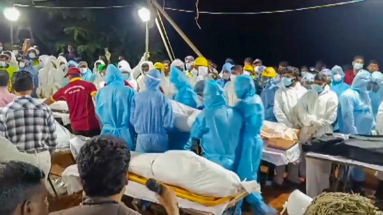 Mass cremation of the unidentified people who lost their lives in the recent landslides at the Pithumala burial ground, in Wayanad, Monday, Aug. 5, 2024