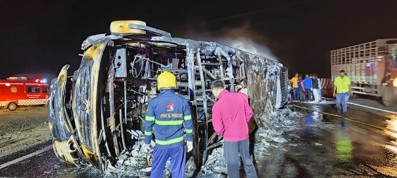 Rescue workers near the passenger bus which met with an accident and caught fire killing 25 passengers on the Samruddhi Expressway