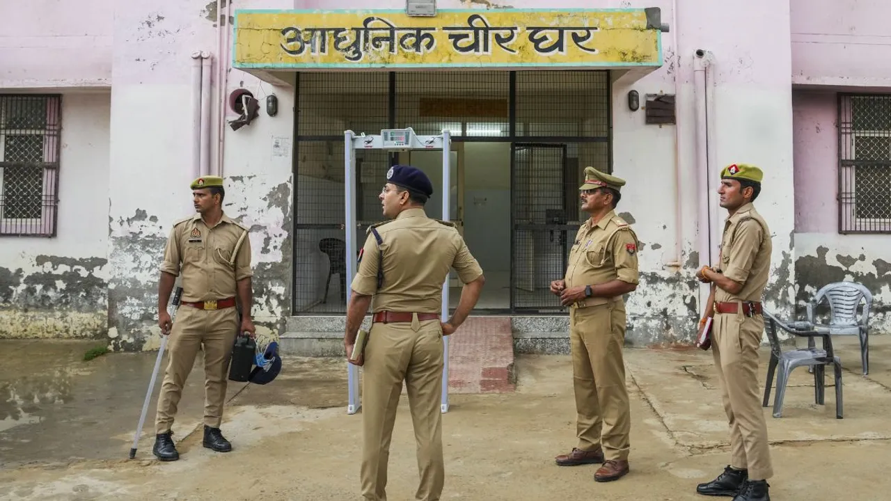 Police personnel keep vigil outside a mortuary a day after a stampede occured during a satsang in Hathras district 
