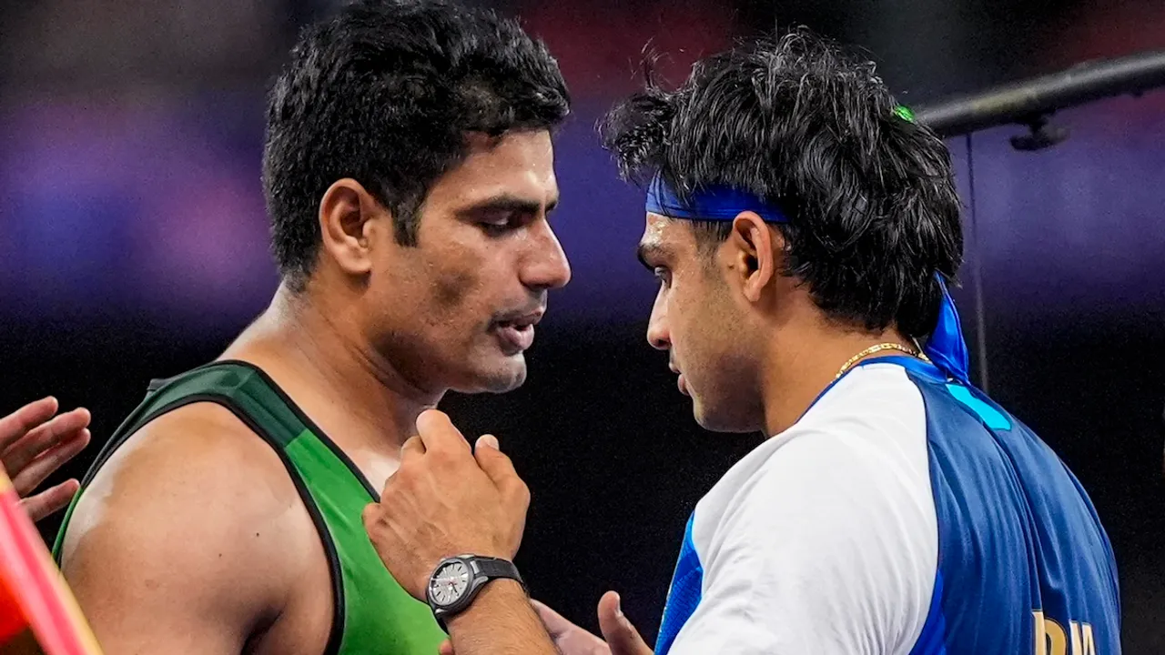 Silver medallist India's Neeraj Chopra and Gold medallist Pakistan's Arshad Nadeem greet each other after the men's javelin throw final at the 2024 Summer Olympics, in Paris, France, Thursday, Aug. 8, 2024.