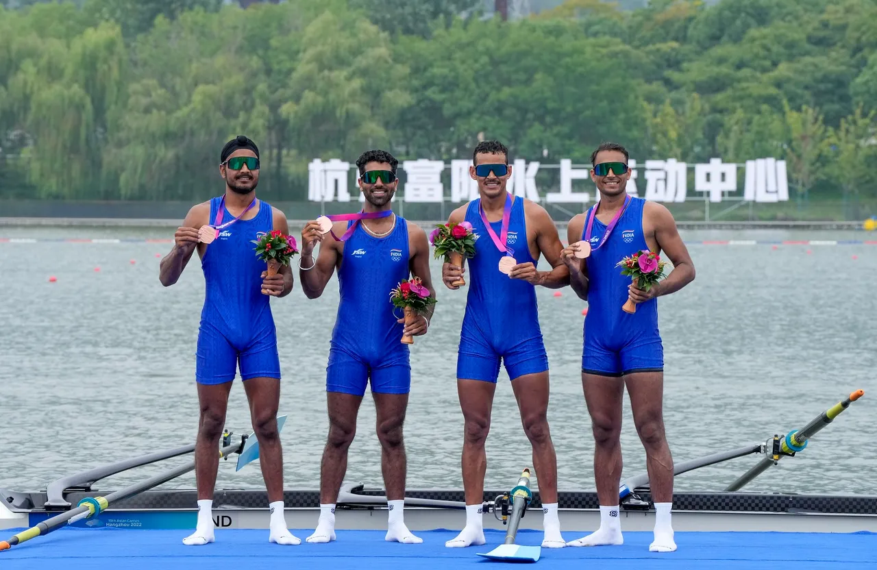 Bronze medal winning Indian team rowers Ashish (R), Punit Kumar (2nd R), Bheem Singh (2nd L) and Jaswinder Singh pose for photographs during the award ceremony