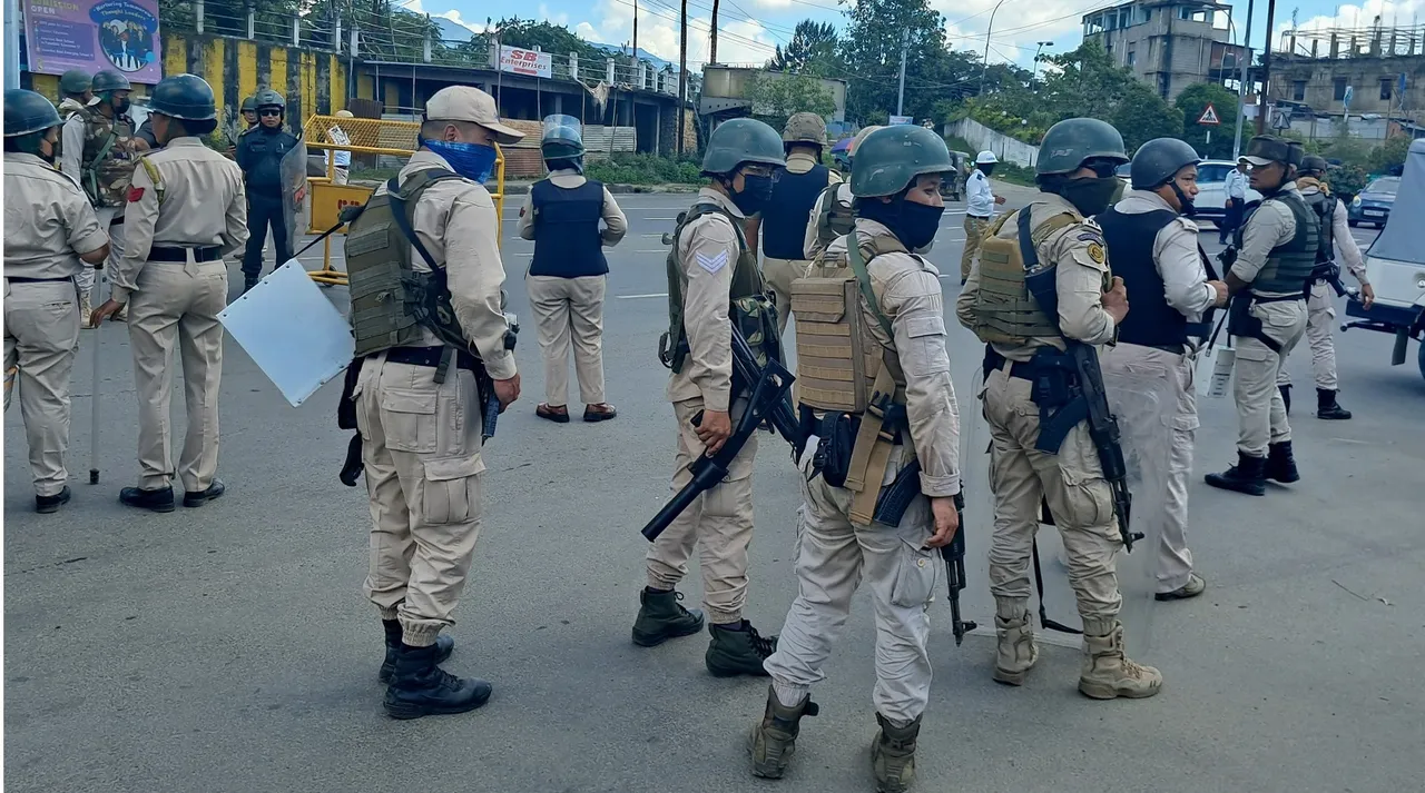Security personnel stand guard at Moirangkhom in Imphal West district