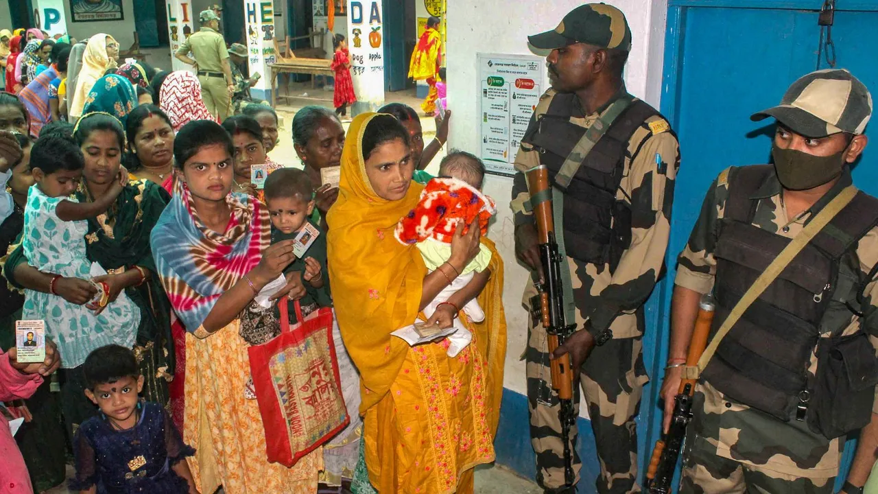 People wait in queues to cast their votes at a polling station during the 3rd phase of Lok Sabha polls, in Malda district, Tuesday, May 7, 2024