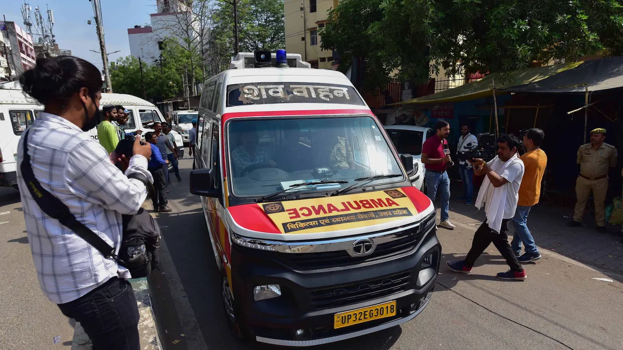An ambulance carries the bodies of mafioso-turned-politician Atiq Ahmed and his brother Khalid Azim aka Ashraf from a hospital in Prayagraj on April 16