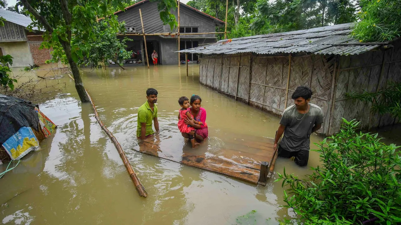 People use a makeshift raft to help a baby safely cross flood waters following heavy rainfall, in Nagaon district, Monday, July 1, 2024.