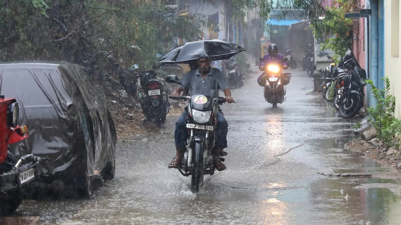 Man on a bike with and umbrella raining