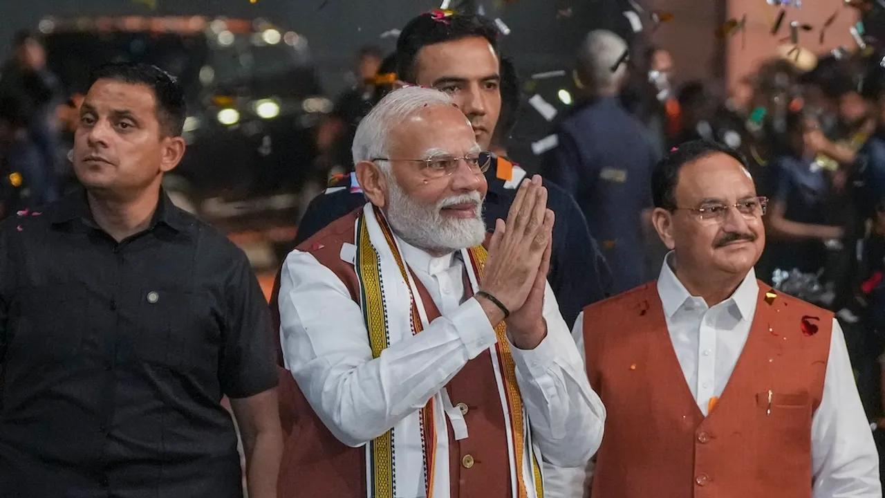 Prime Minister Narendra Modi greets the gathering upon his arrival at the party headquarters during an event after the declaration of results for the Haryana and Jammu and Kashmir Assembly elections, in New Delhi, Tuesday, Oct. 8, 2024