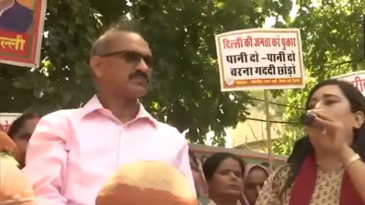 BJP MP from New Delhi Bansuri Swaraj takes part in 'matka-phod' protest against Delhi government over the water shortage in Delhi.