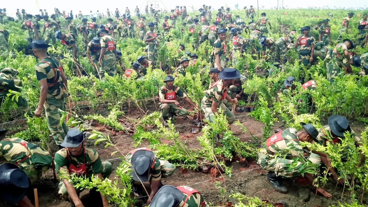Security personnel plant saplings during a plantation drive under the 'Ek Ped Maa Ke Naam' campaign, in Indore, Sunday, July 14, 2024.