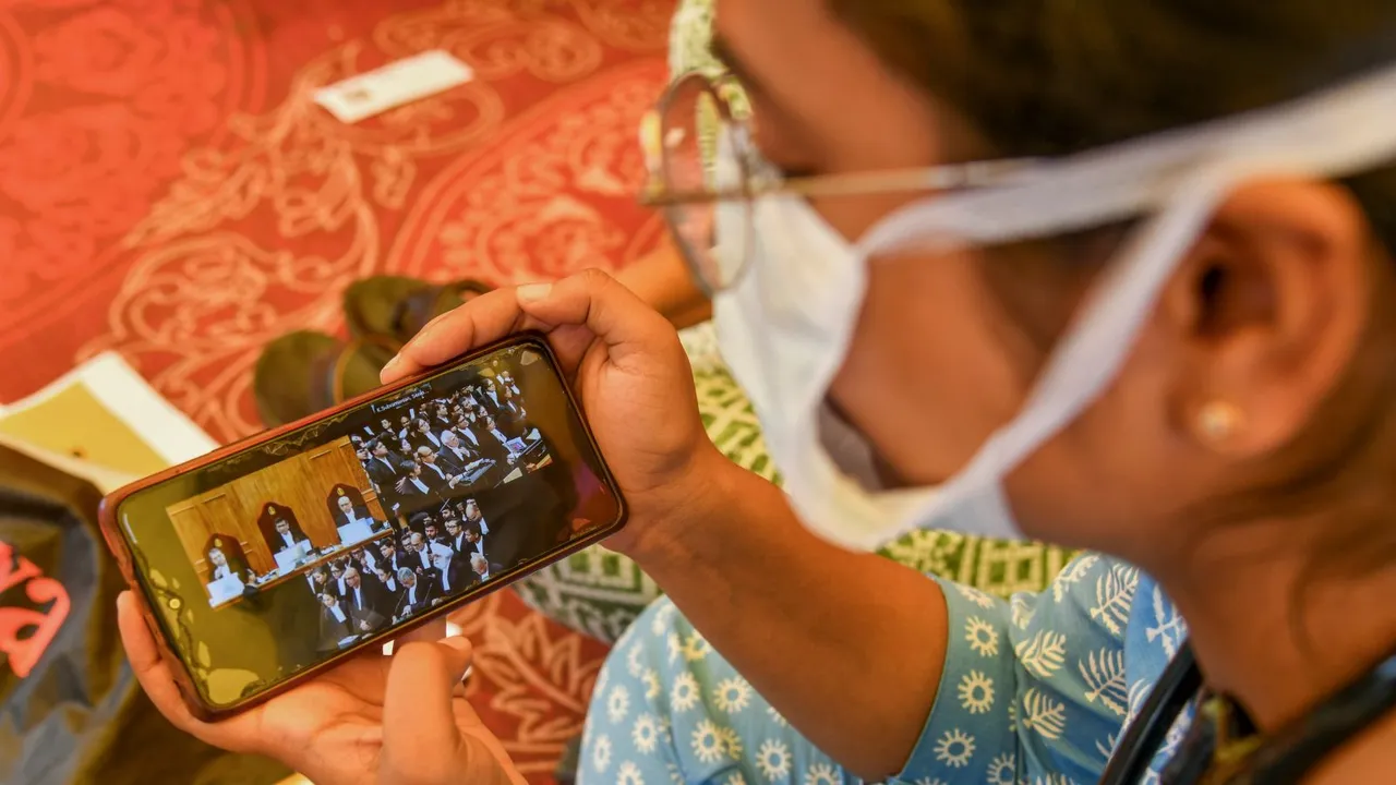 A doctor watches the Supreme Court hearing on her mobile, on a suo moto case related to the alleged sexual assault and murder of a postgraduate trainee doctor in Kolkata, at the Supreme Court in New Delhi, Tuesday, August 20, 2024