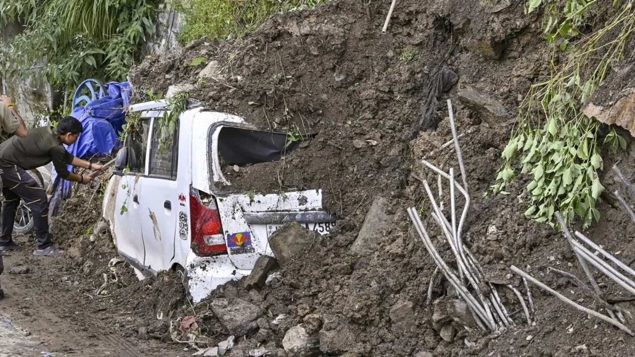 A vehicle buried under the debris after landslide at Sanjauli, in Shimla, on Wednesday