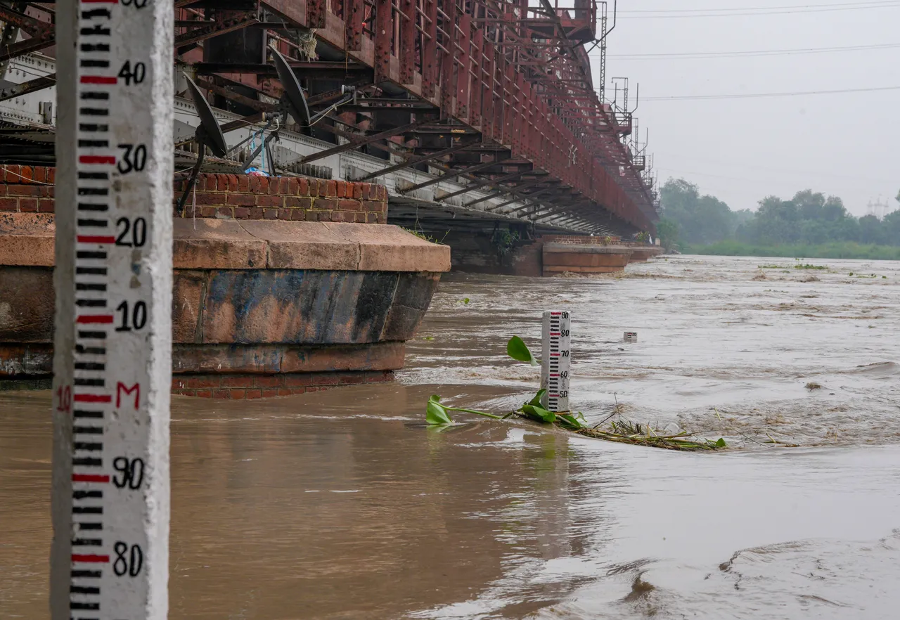 The swollen Yamuna River flows in spate under the Old Yamuna Bridge
