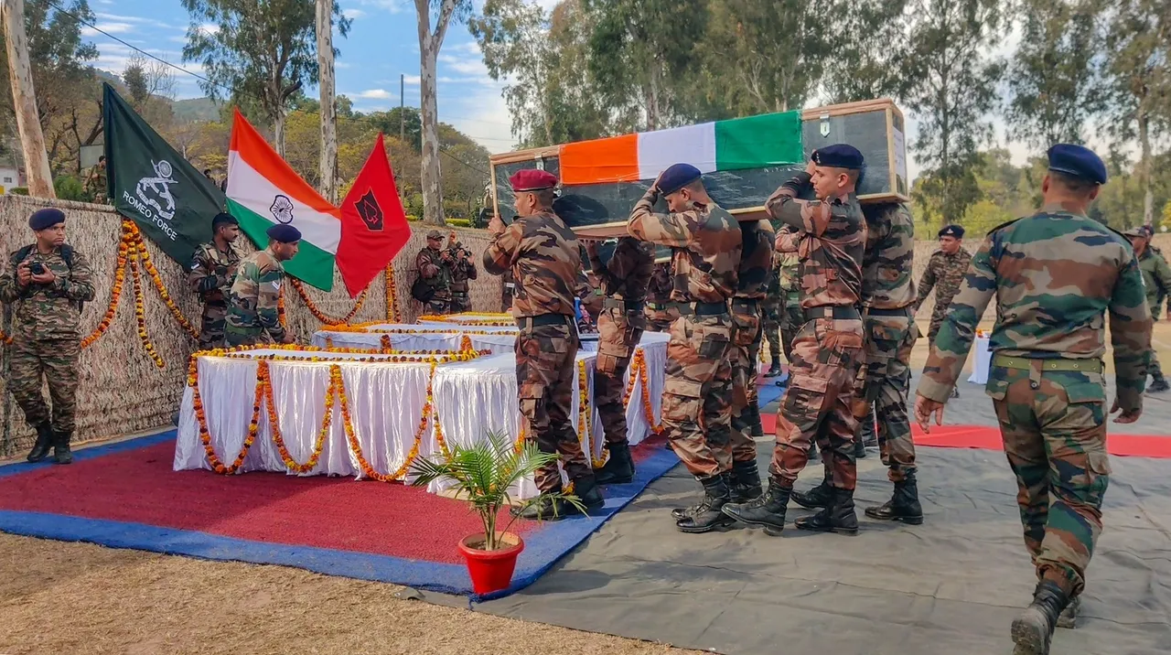 Army soldiers carry mortal remains of four Army personnel killed in a recent militant attack during a wreath laying ceremony, in Poonch