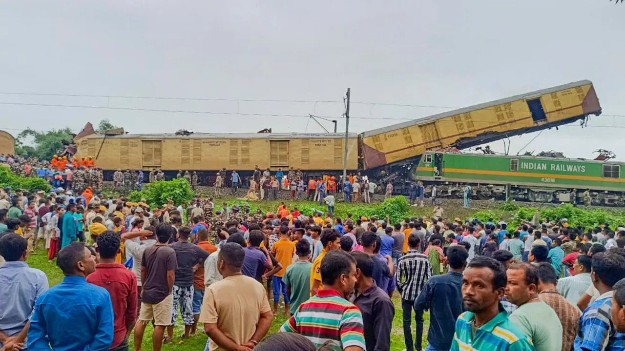 Locals gather after a collision between the Kanchanjungha Express and a goods train, near Rangapani railway station, on Monday, June 17, 2024.
