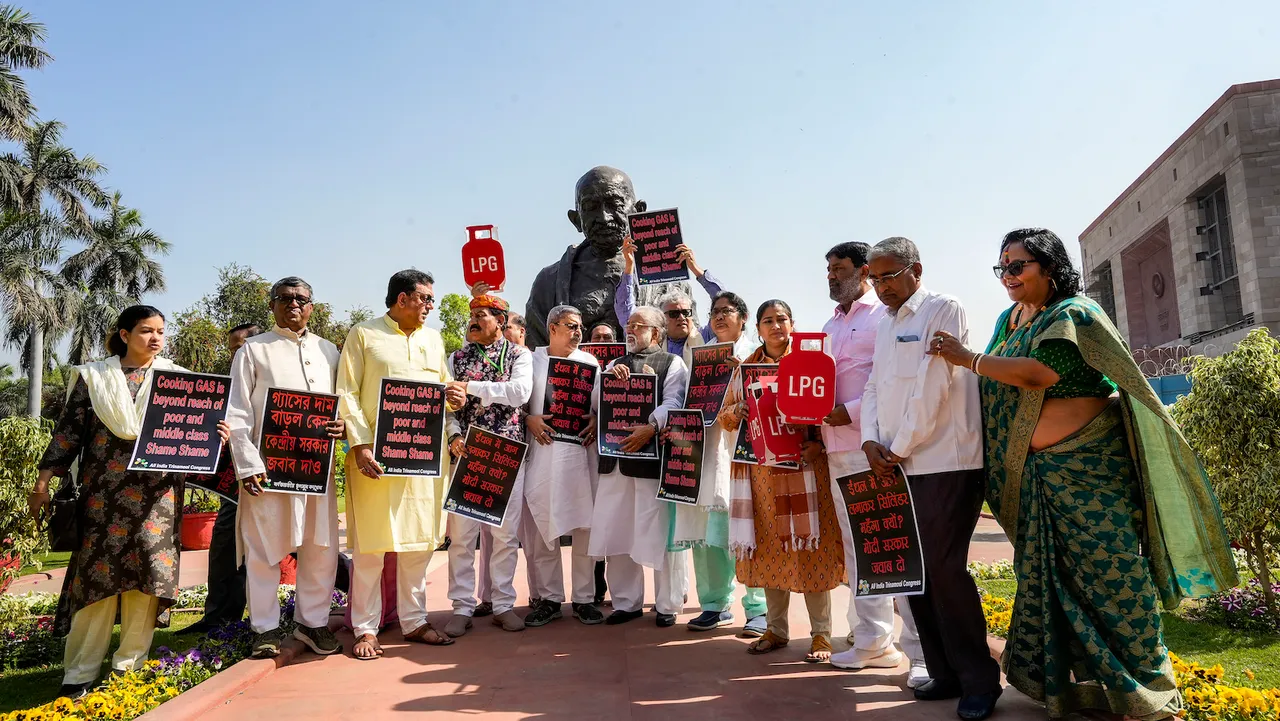 TMC MPs stage a protest near the statue of Mahatma Gandhi against hike in price of LPG cylinder during the Budget Session of Parliament