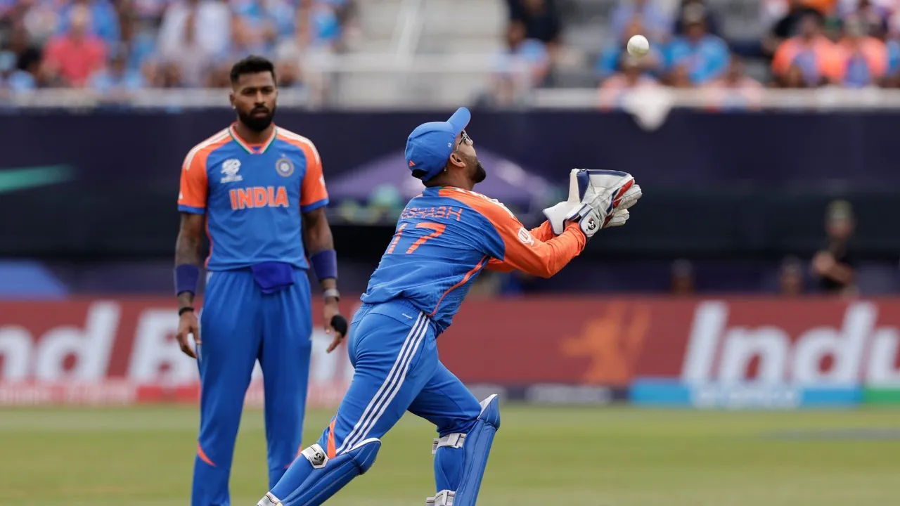 India's Hardik Pandya, left, watches as teammate Rishabh Pant prepares to take the catch to dismiss United States' Corey Anderson during the ICC Men's T20 World Cup cricket match