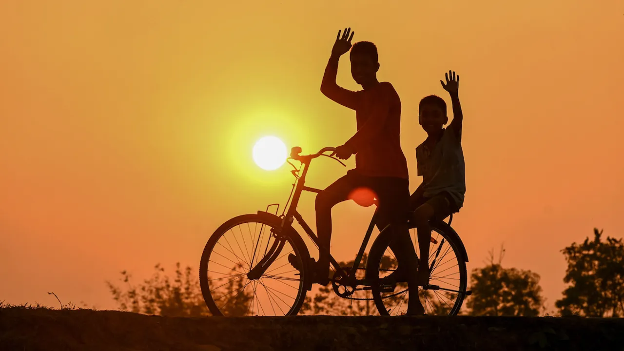 A boy rides a bicycle during the last sunset in Joypur village, on the outskirts of Agartala, Sunday, Dec. 31, 2023.