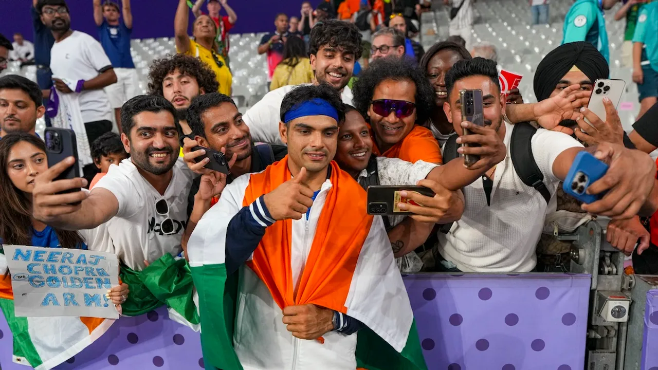 Silver medallist India's Neeraj Chopra with fans after the men's javelin throw final at the 2024 Summer Olympics, in Paris, France, Thursday, Aug. 8, 2024.