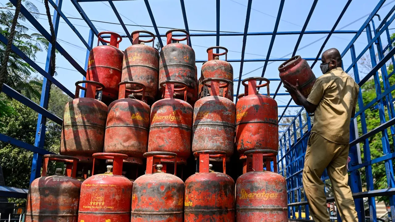 In this Feb. 1, 2024 file photo, a worker arranges LPG cylinders in a lorry, at a distribution center in Bengaluru