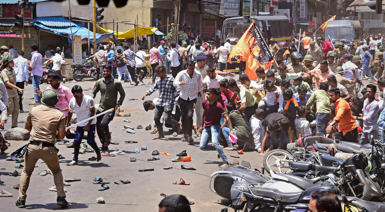 Security personnel disperse people protesting against the alleged use of Tipu Sultan’s image in objectionable social media posts, in Kolhapur