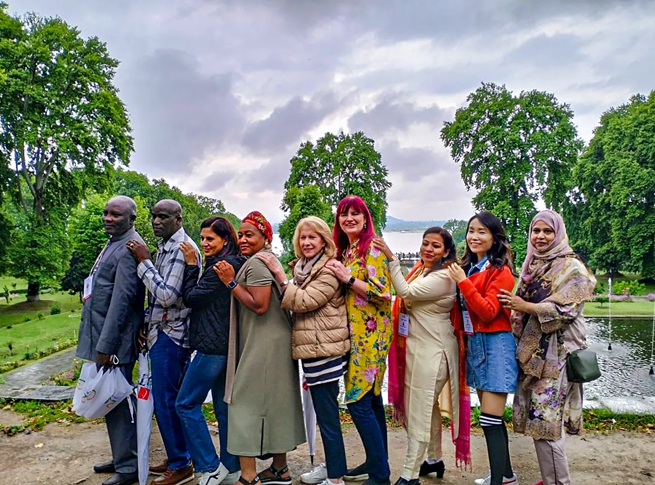 G20 delegates pose for a photo at Nishat Garden on the banks of Dal Lake, in Srinagar