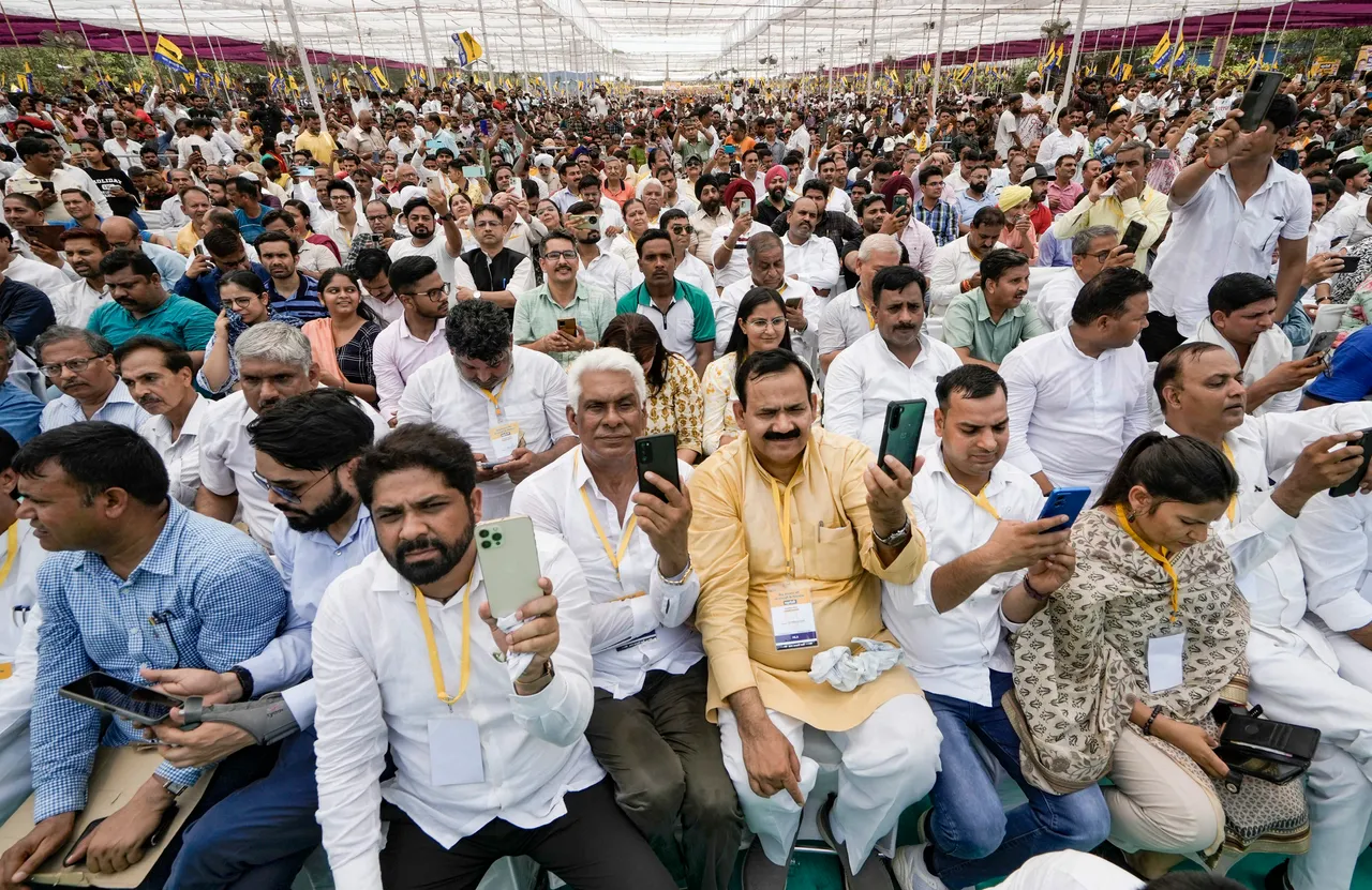 AAP supporters gather during the party's 'maha rally' against the Centre's ordinance on control of services in the national capital, at Ramlila Maidan