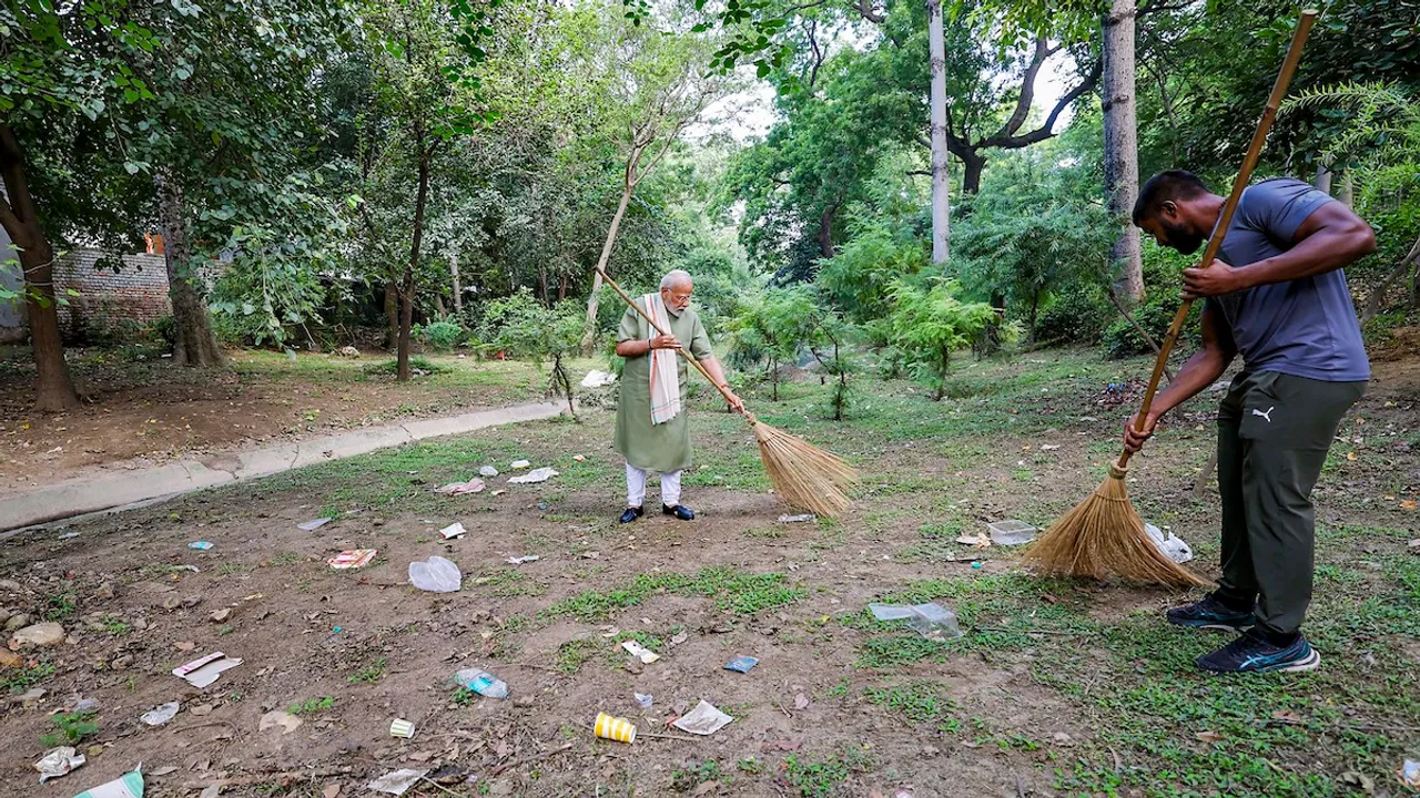 Narendra Modi with wrestler Ankit Baiyanpuriya participates in a special cleanliness programme ‘Ek Taarikh, Ek Ghanta, Ek Saath’ (Shramdaan) under 'Swachchta hi Seva' campaign ahead of Gandhi Jayanti, in New Delhi, Sunday, Oct. 1,