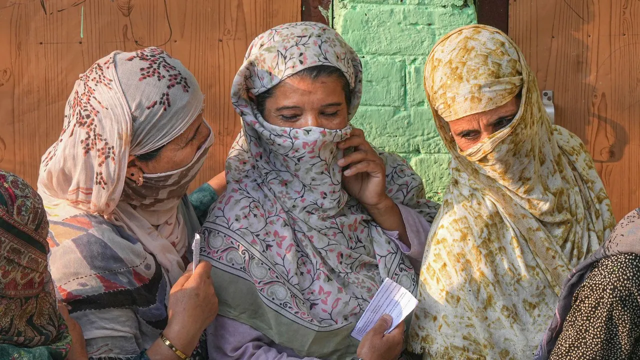 Voters stand in a queue at a polling station to cast votes during the second phase of Jammu and Kashmir Assembly elections, in Srinagar district, Wednesday, Sept. 25, 2024.