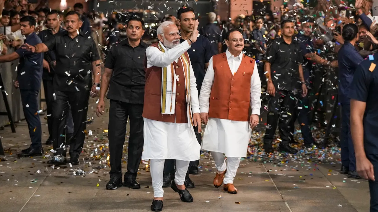 Prime Minister Narendra Modi greets the gathering upon his arrival at the party headquarters during an event after the declaration of results for the Haryana and Jammu and Kashmir Assembly elections, in New Delhi, Tuesday, Oct. 8, 2024. Union Minister and BJP National President JP Nadda is also seen.