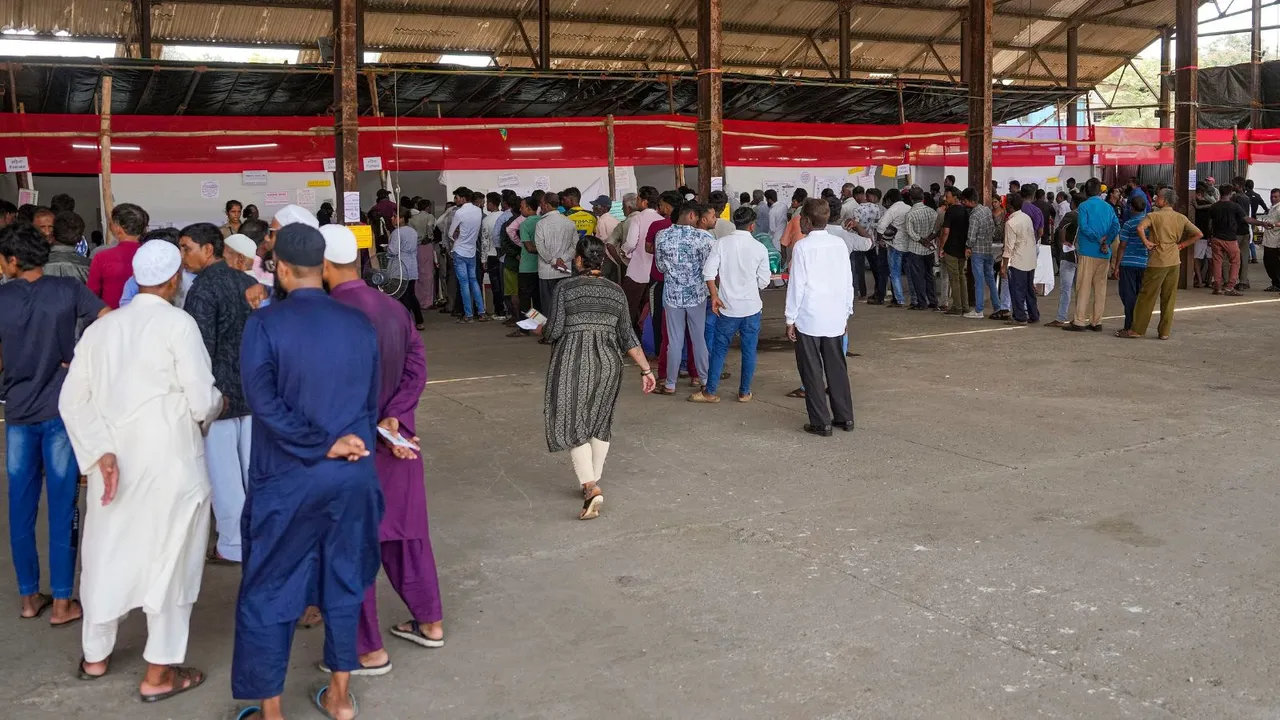 Voters wait at a polling station to cast their votes for the fifth phase of Lok Sabha elections, in Mumbai, Monday, May 20, 2024