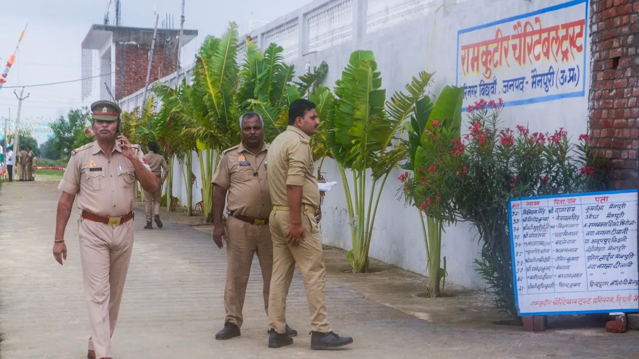 Police personnel outside Ram Kutir Charitable Trust, the ashram of preacher Baba Narayan Hari, also known as Saakar Vishwa Hari Bhole Baba, at Bichhwa, in Mainpuri district, Thursday, July 4, 2024.