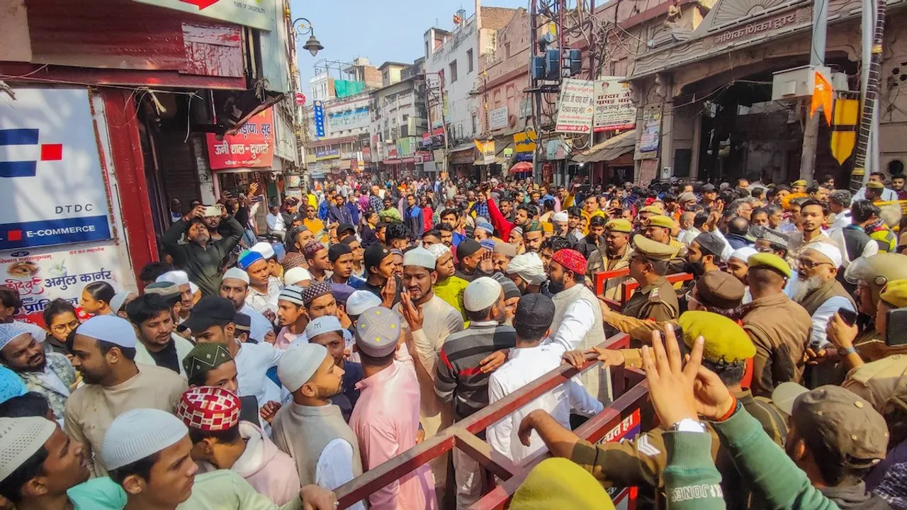 Police personnel stop Muslims as they gather to offer 'namaz' at Gyanvapi Mosque, in Varanasi, Friday, Feb. 2, 2024