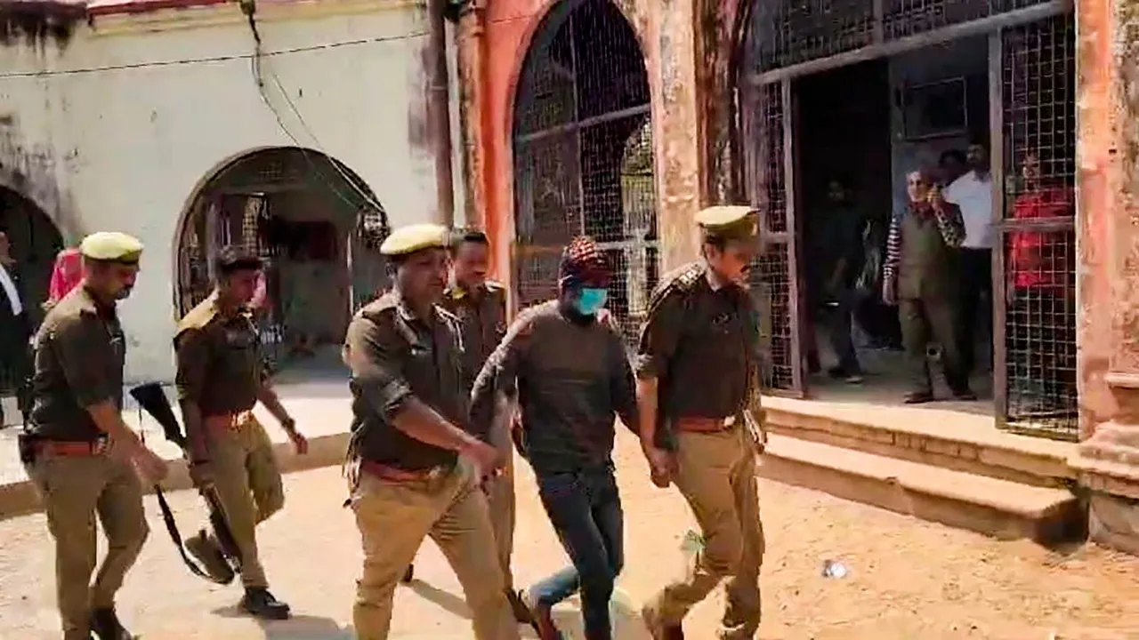 Brother of the main accused in the murder case of two children in Budaun, Javed being taken to jail after he was produced before the CJM court, in Budaun