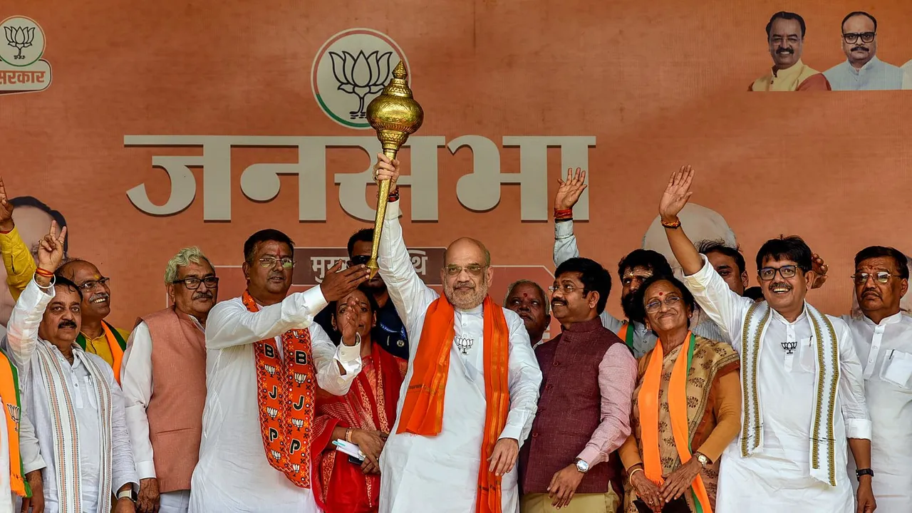 Union Home Minister Amit Shah with BJP candidate from Allahabad constituency Neeraj Tripathi a public meeting for Lok Sabha polls, near Prayagraj, Sunday, May 19, 2024