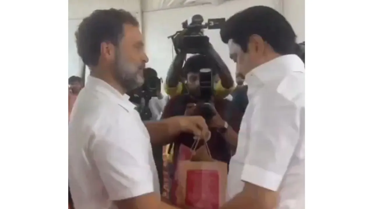 Congress leader Rahul Gandhi giving Mysore Pak to DMK president M K Stalin on Saturday
