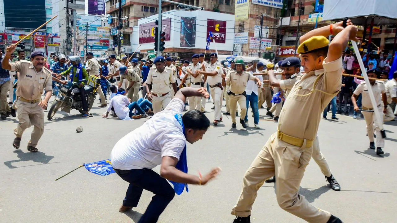 Police personnel lathi-charge protestors during the 'Bharat Bandh' called by SC/ST organisations over reservation issue, in Patna, Wednesday, Aug. 21, 2024.
