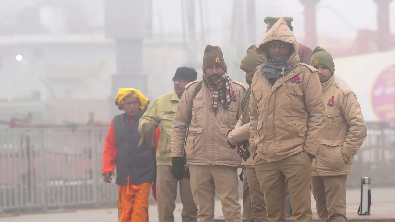 Security personnel stand guard during a cold and foggy winter morning, in Ayodhya