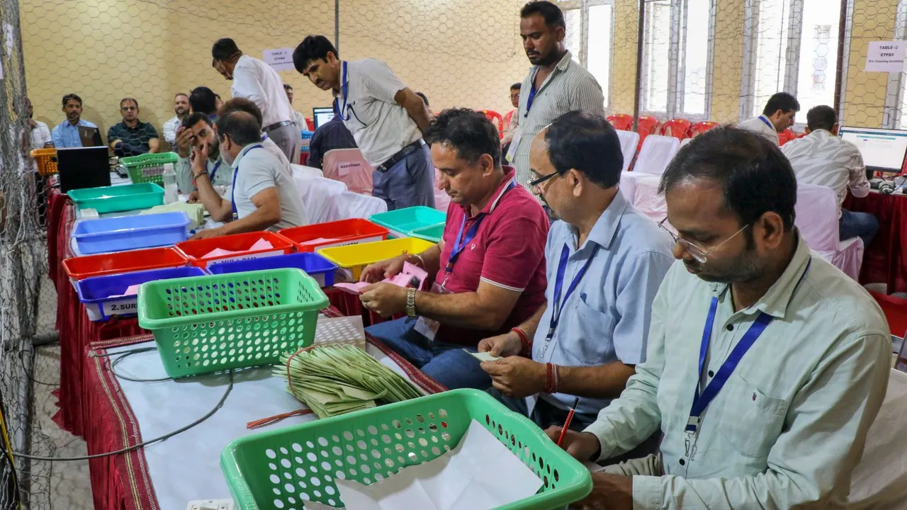 Election officials count votes for the Jammu & Kashmir Assembly elections, at Polytechnic College counting center, in Jammu, Tuesday, Oct. 8, 2024.