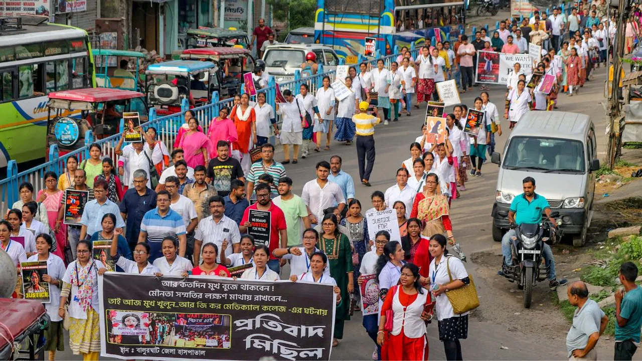 Doctors and other medical staff of district government hospital take part in a protest march demanding justice for the postgraduate trainee doctor who was allegedly raped and murdered at Kolkata's R G Kar Medical College and Hospital, in Balurghat, Wednesday, Aug. 21, 2024