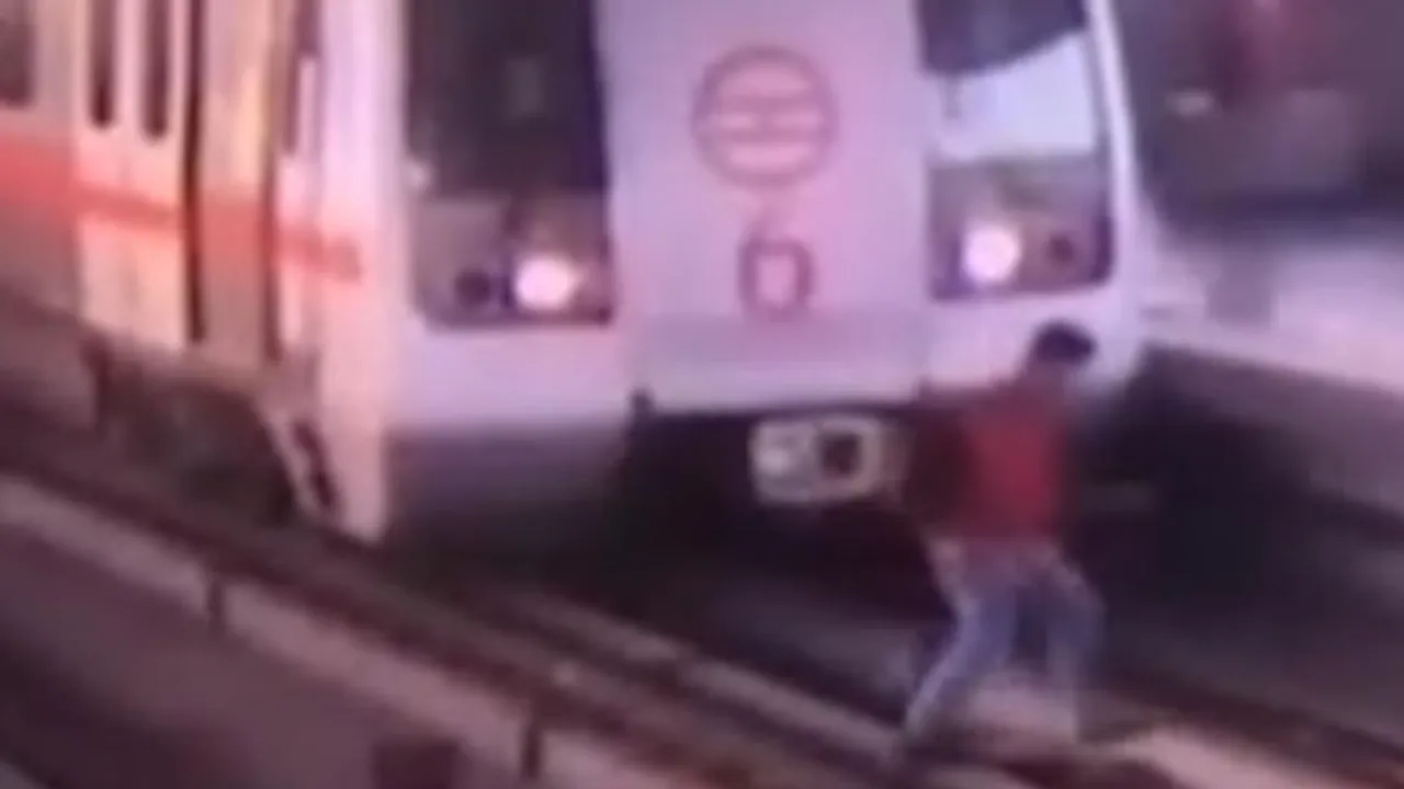 man on metro track