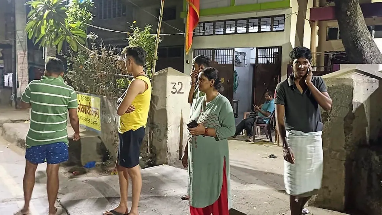 People come out of their homes after tremors were felt due to an earthquake, in Patna, Friday night, Nov 3, 2023.