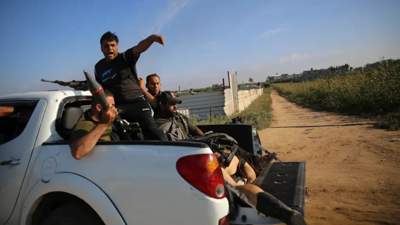 Hamas terrorists with dead body of an Israeli girl