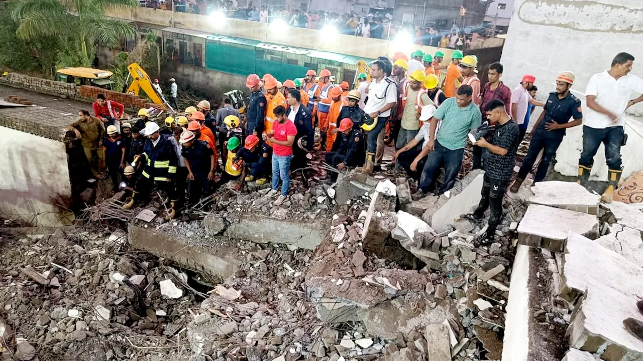 Officials and others during a rescue operation after a building collapse, in Surat, Saturday, July 6, 2024.