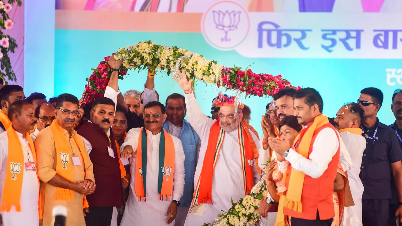 Union Home Minister Amit Shah and Madhya Pradesh BJP President VD Sharma being garlanded during the launch of the party's 'Jan Ashirwad Yatra', in Mandla district