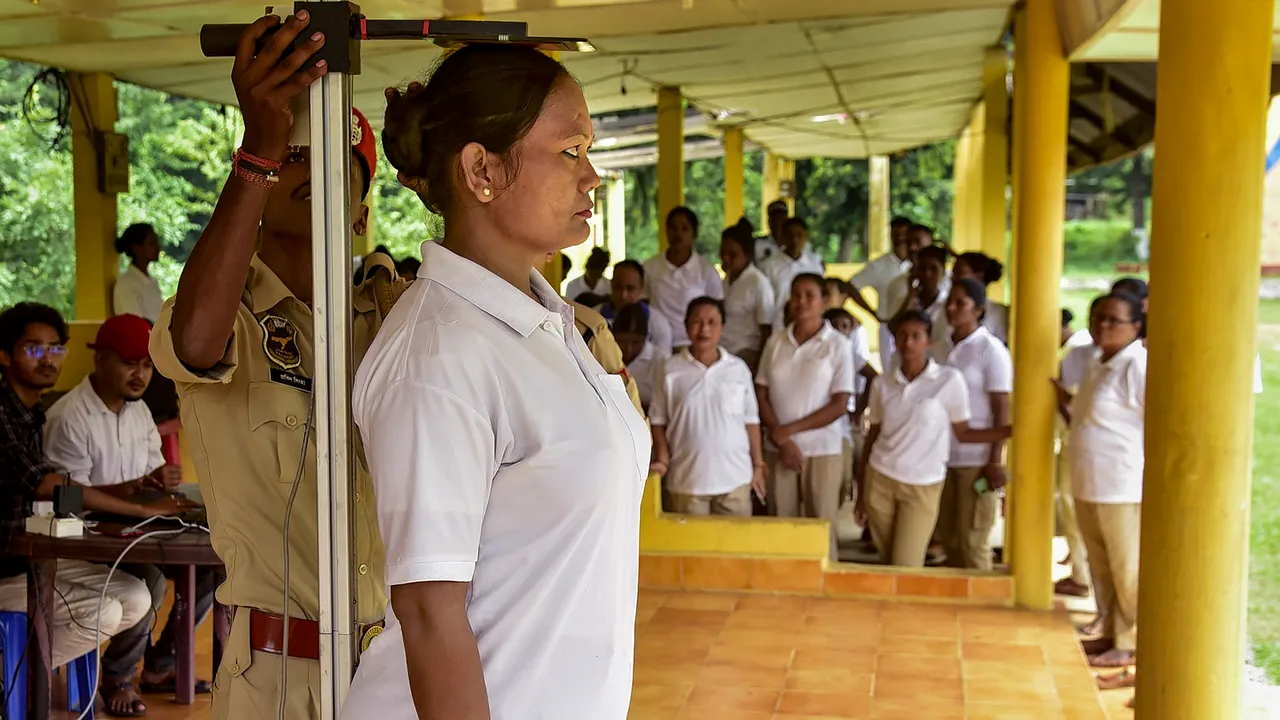 A woman police personnel gets her height measured during a Body Mass Index (BMI) assessment for Assam Police personnel, in Guwahati