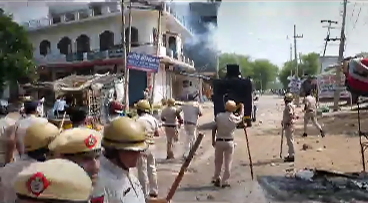 Security personnel attempt to disperse miscreants after stones were pelted at a 'Brij Mandal Jalabhishek Yatra' in Nuh on Monday, July 31
