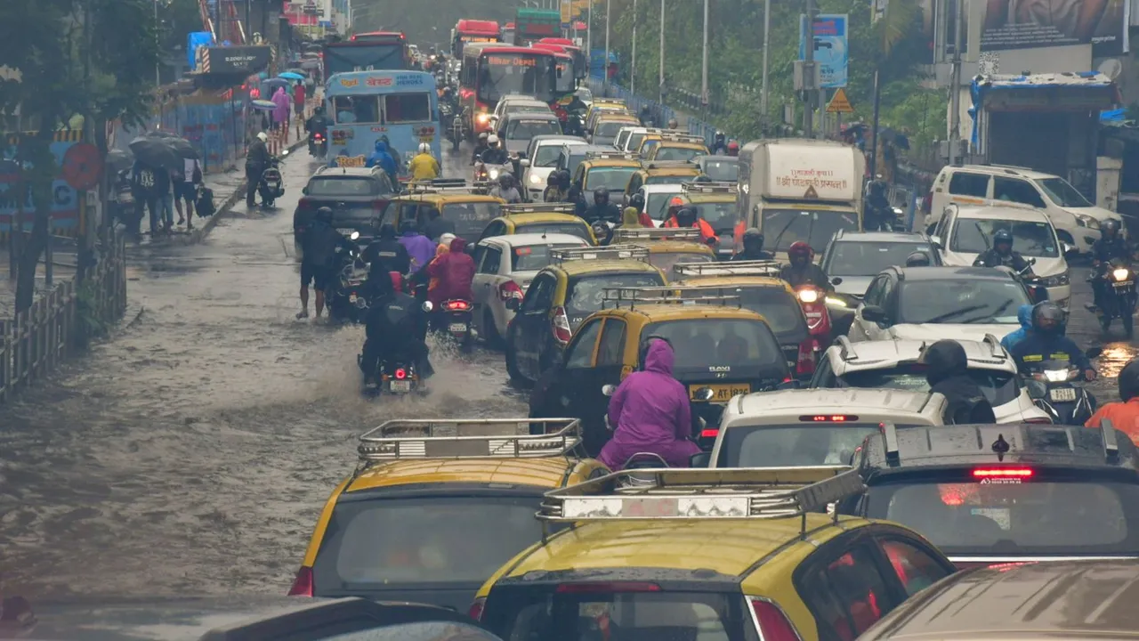 Vehicles move on a waterlogged road after heavy monsoon rain, at Dadar in Mumbai, Sunday, July 21, 2024.