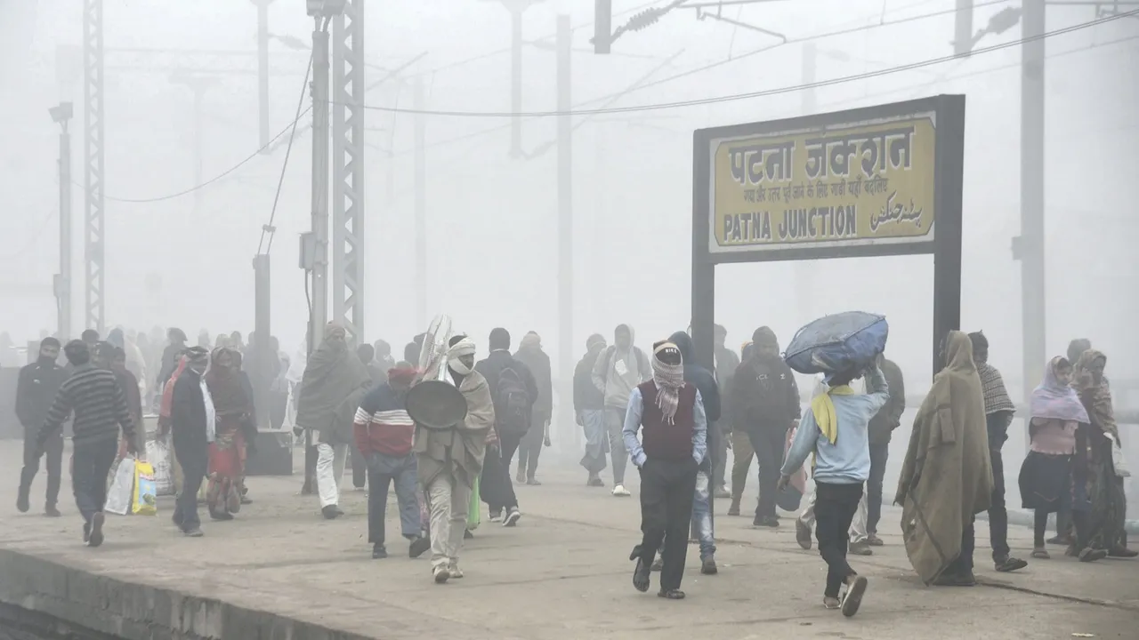 Commuters at the Patna Junction railway station during fog on a cold winter morning, in Patna