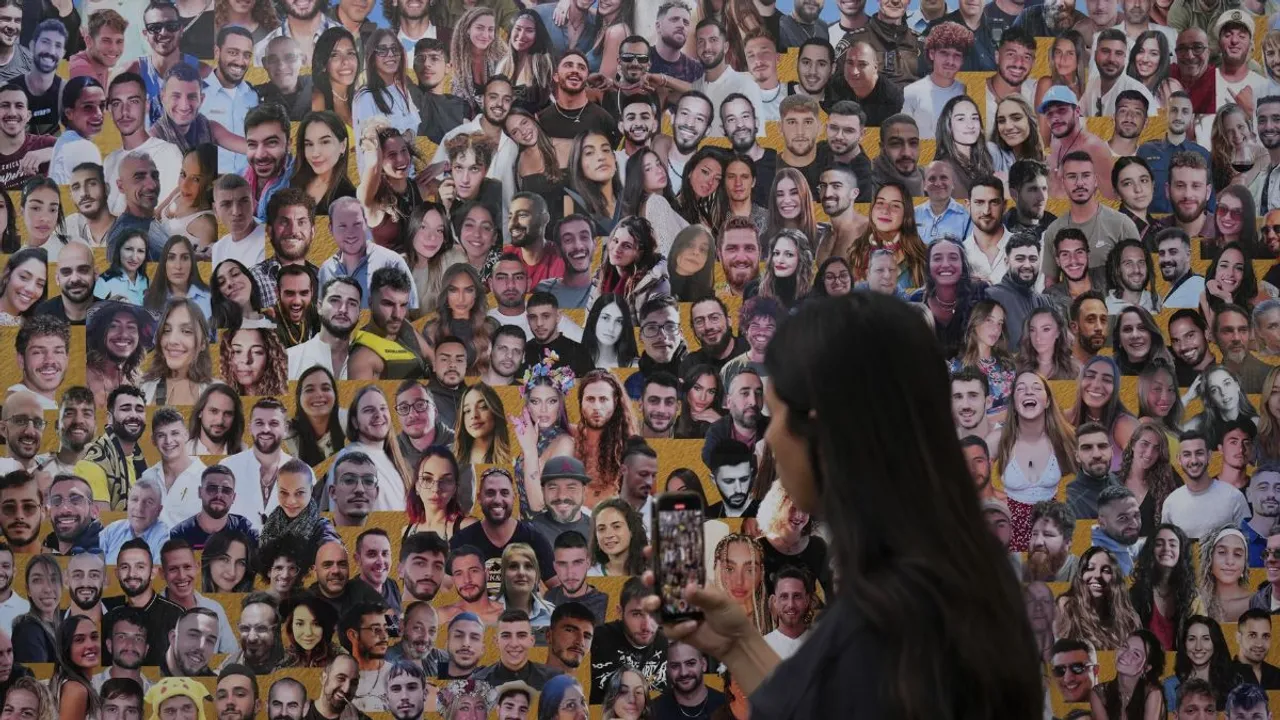 An attendant walks through a mural of victims at the Nova music festival site near Kibbutz Reim, Israel, on the one-year anniversary of the Hamas attack, October 7, 2024