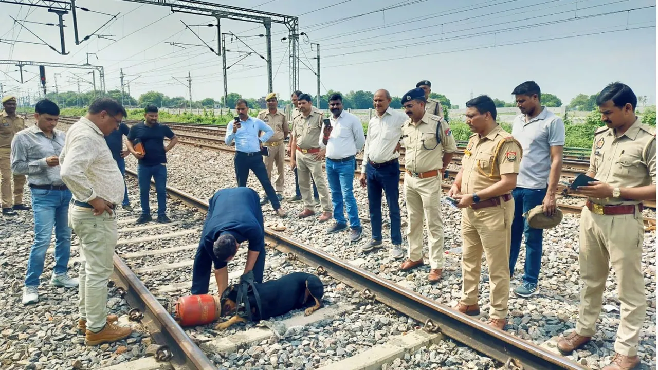 Railway officials remove a gas cylinder from the railway track near Prempur Station, in Kanpur, Sunday, Sept. 22, 2024.